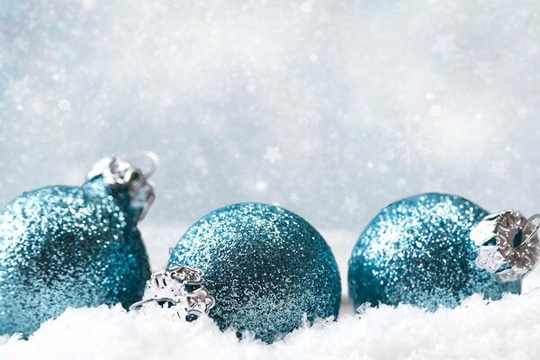 Turquoise Christmas balls in the snow