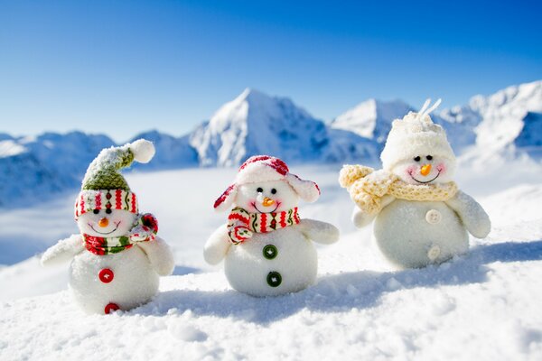 Three snowmen in scarves and hats