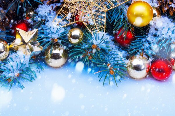 A scattering of Christmas tree toys on fir branches