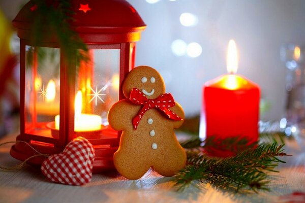 Lantern with a candle and cookies, in the form of a snowman for the New Year