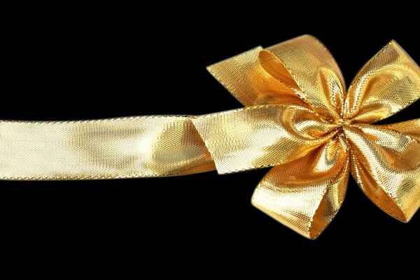 Gold shiny bow on a black background