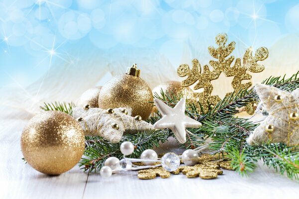 Christmas decoration with golden Christmas balls and stars, silver balls and stars lying on a fir branch