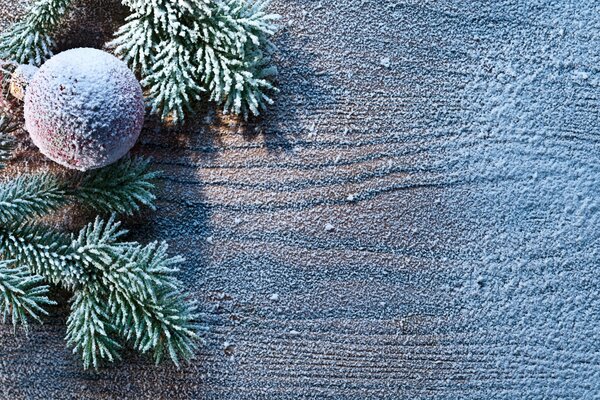 Snow-covered Christmas tree toy on the surface