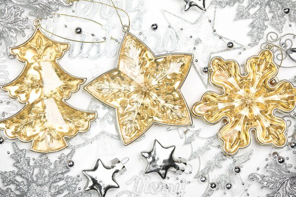 Golden toys on a background of gray snowflakes