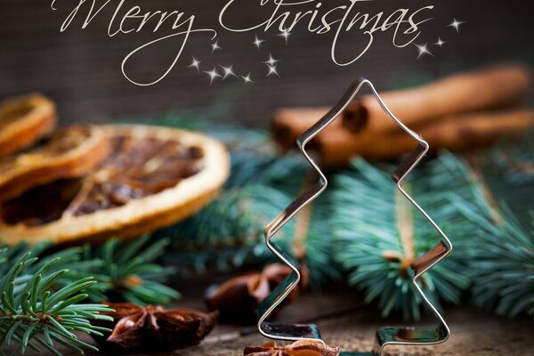 Carte de voeux avec un souhait de joyeux Noël sur le thème avec la forme de l arbre de Noël, des brindilles et des clous de girofle