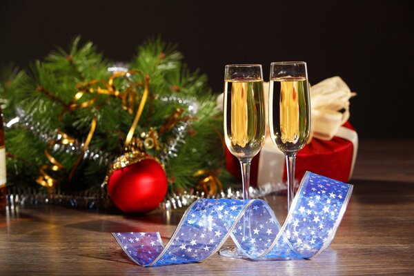 Two glasses of champagne on the background of Christmas toys