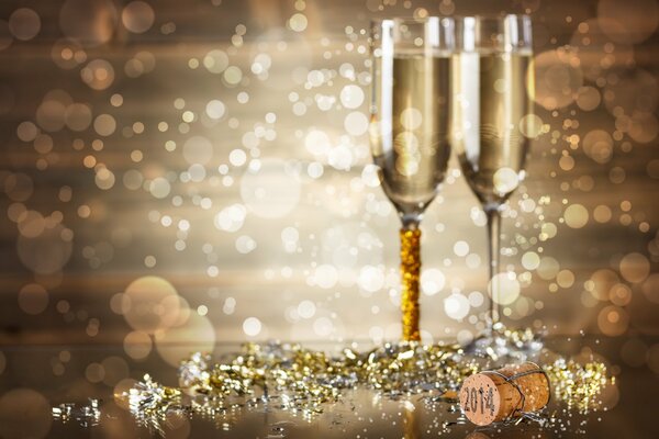 Two glasses of champagne in the new year on a golden background