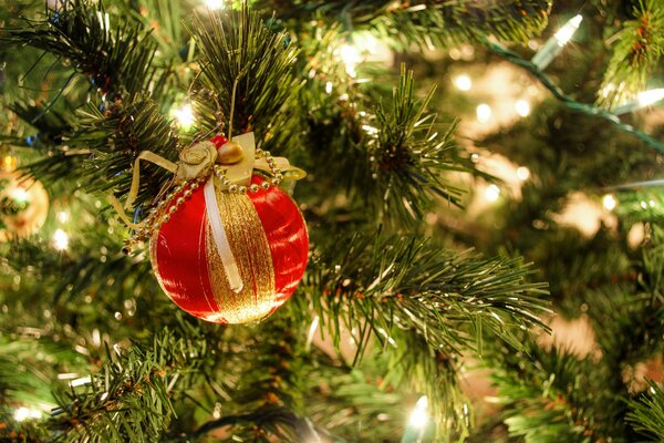 Photo of a festive Christmas tree for the New Year. New Year s ball on the Christmas tree photo with a garland