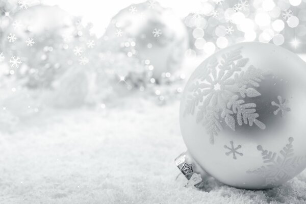 Christmas tree toy on the background of snow in the theme of the new year