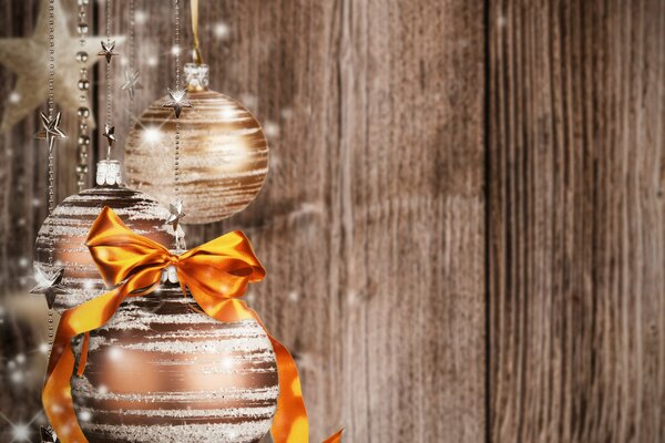 Christmas balls with bows on a brown background