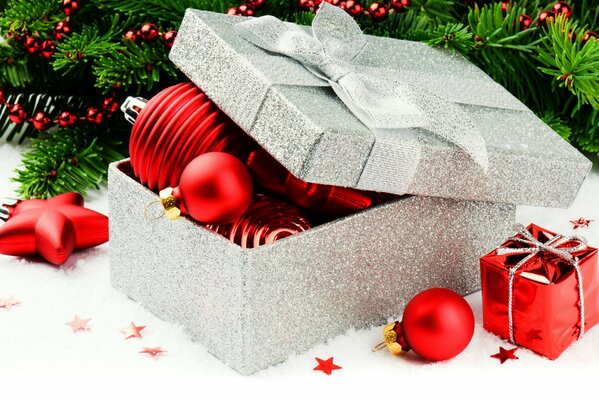 Red Christmas decorations in a silver gift box