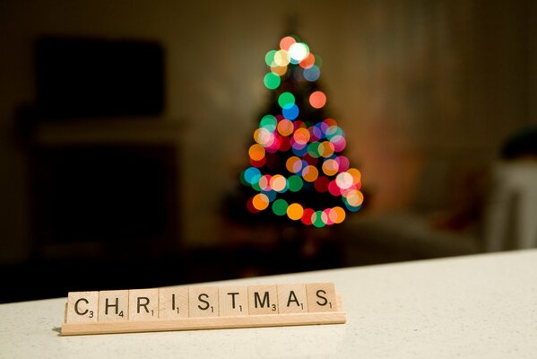 Scrabble game on the background of a Christmas tree