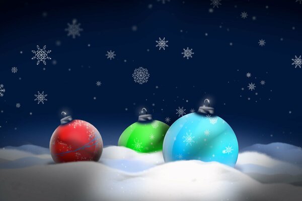 Tre palline colorate di Natale sulla neve