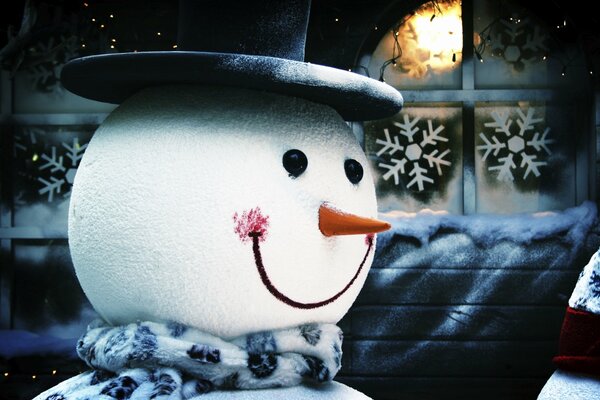 Funny snowman in a black top hat