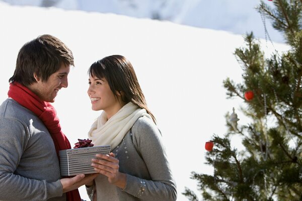 Heureux gars et fille se donnent des cadeaux