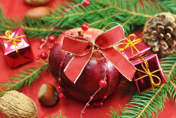 Christmas tree toys, cones and nuts on a red background