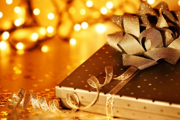 A gift for Christmas in a festive package with a golden bow