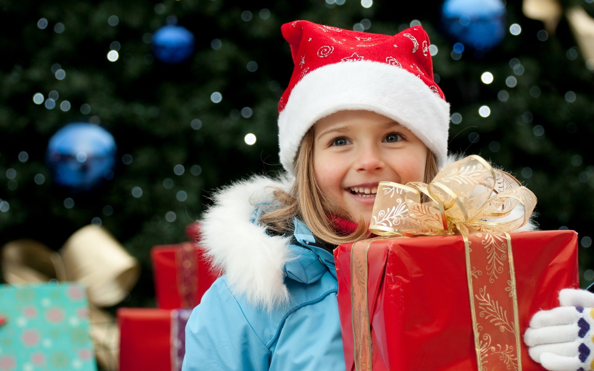 new year holiday children girl present red box gold belt bow blue jacket hat gloves smile