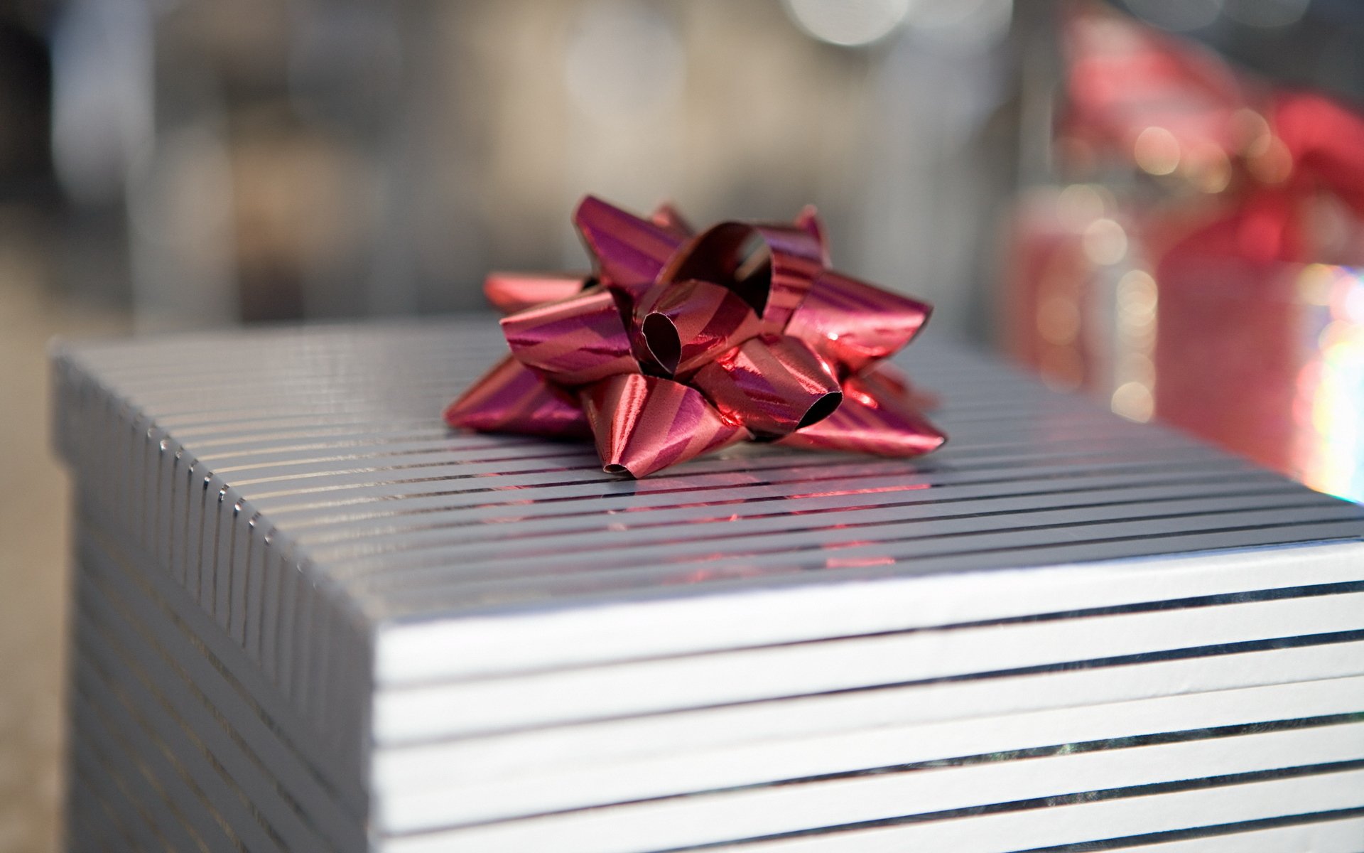 holiday new year gift silver packaging striped box red bow rest silver red