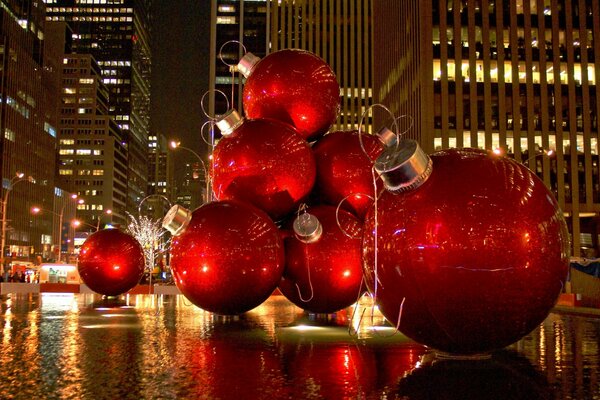 The street is decorated with huge red Christmas balls