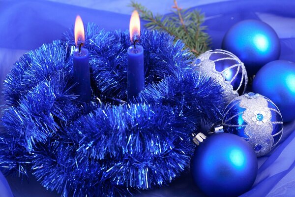 Blue candles in blue tinsel