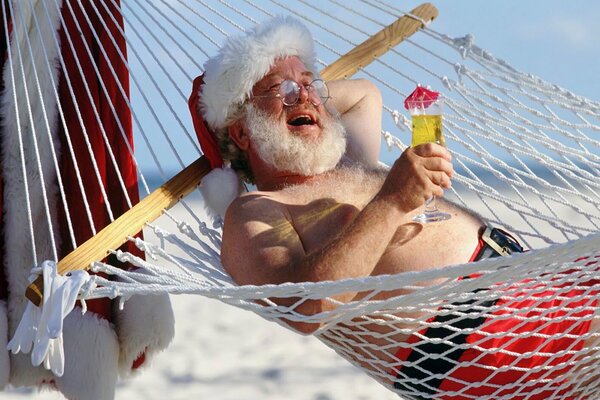 Santa Claus in a hammock with a cocktail