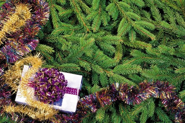 New Year s gift at the Christmas tree with tinsel