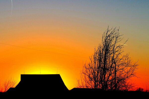 Über dem Haus ziert der Himmel einen roten Sonnenuntergang