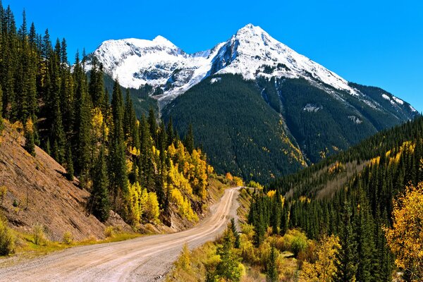 Snow in the mountains, the road going to the slope