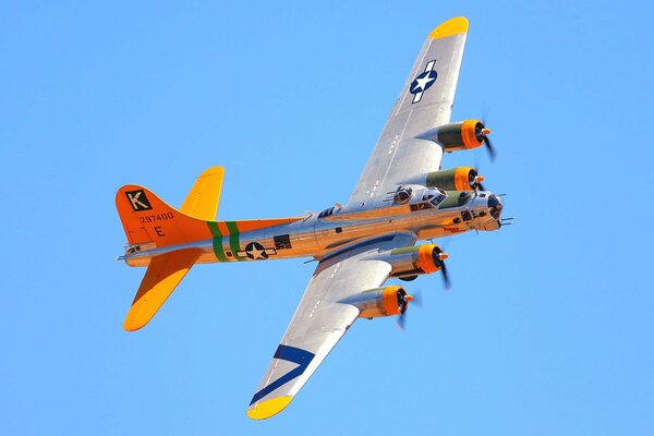 A bright airplane in flight. Blue sky on the background