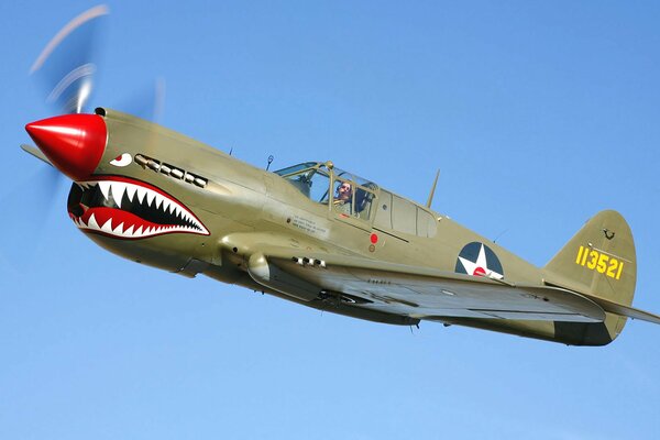 The nose of the fighter plane is painted in a shark s mouth