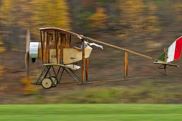 The codron g iii aircraft with a pilot inside is flying close to the ground