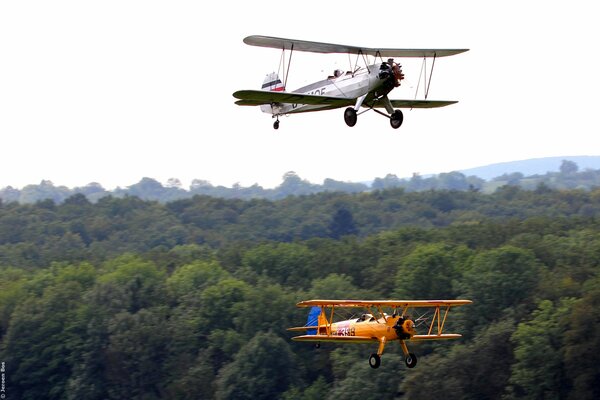 Two cornhusker planes over the forest