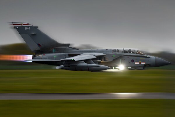 Military fighter bomber takes off