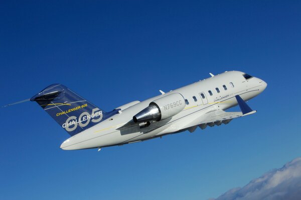 A passenger plane is flying in the clouds