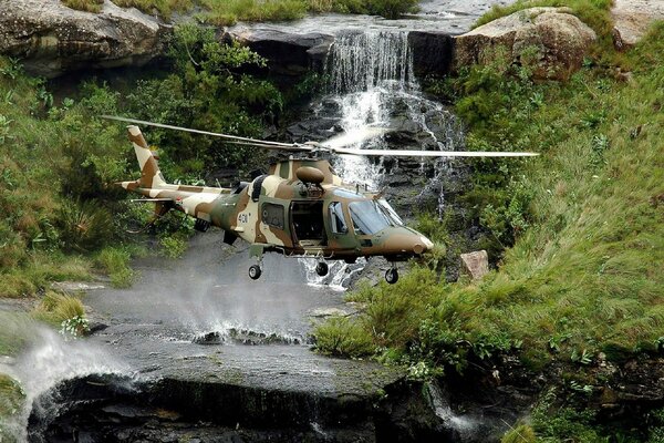 Helicopter on the background of a waterfall and a river