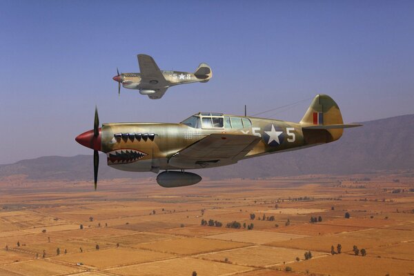 Two American military planes fly over the desert