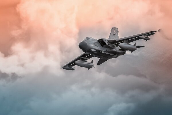 The fighter is flying rapidly through a bunch of clouds