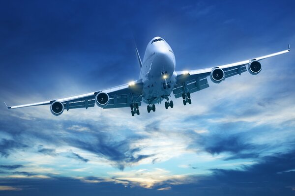 A plane flying against a blue sky background