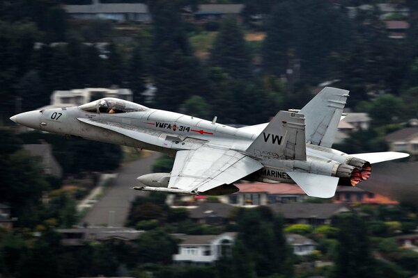 A military plane flies over the city