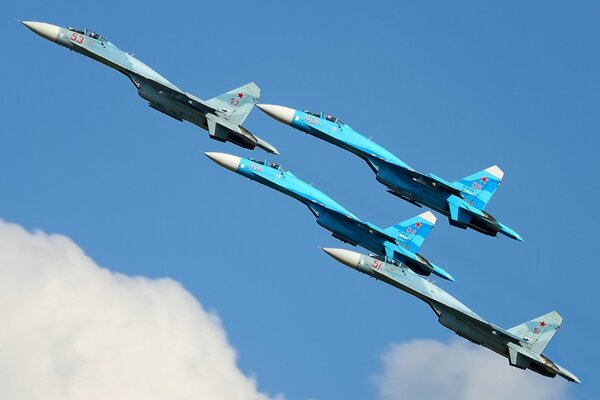 Fighter planes in the sky su-27 between the clouds