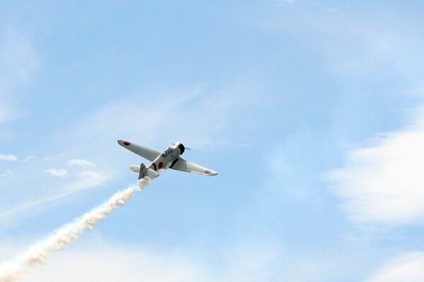 A plane is flying in the blue sky