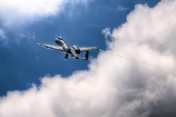 A plane flying in the sky above the clouds