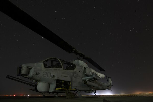Helicopter on the pad against the background of the night sky
