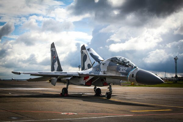 Su 27 fighter jet at the airfield against the sky