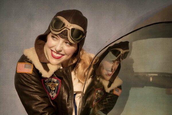 A girl poses in a uniform of a military pilot