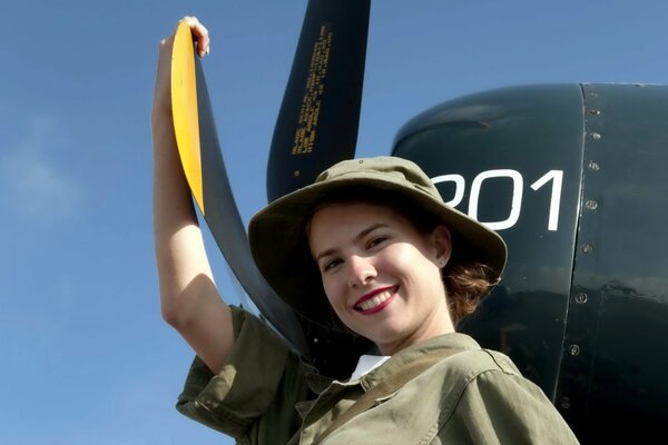 A young girl on the background of an airplane