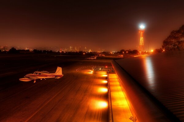 The plane is parked at the night airport