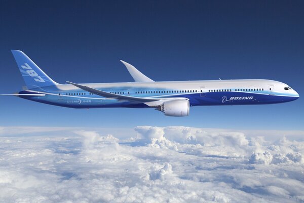 A blue plane is flying above the clouds