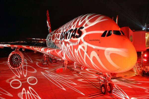 Boeing plane illuminated by night lights